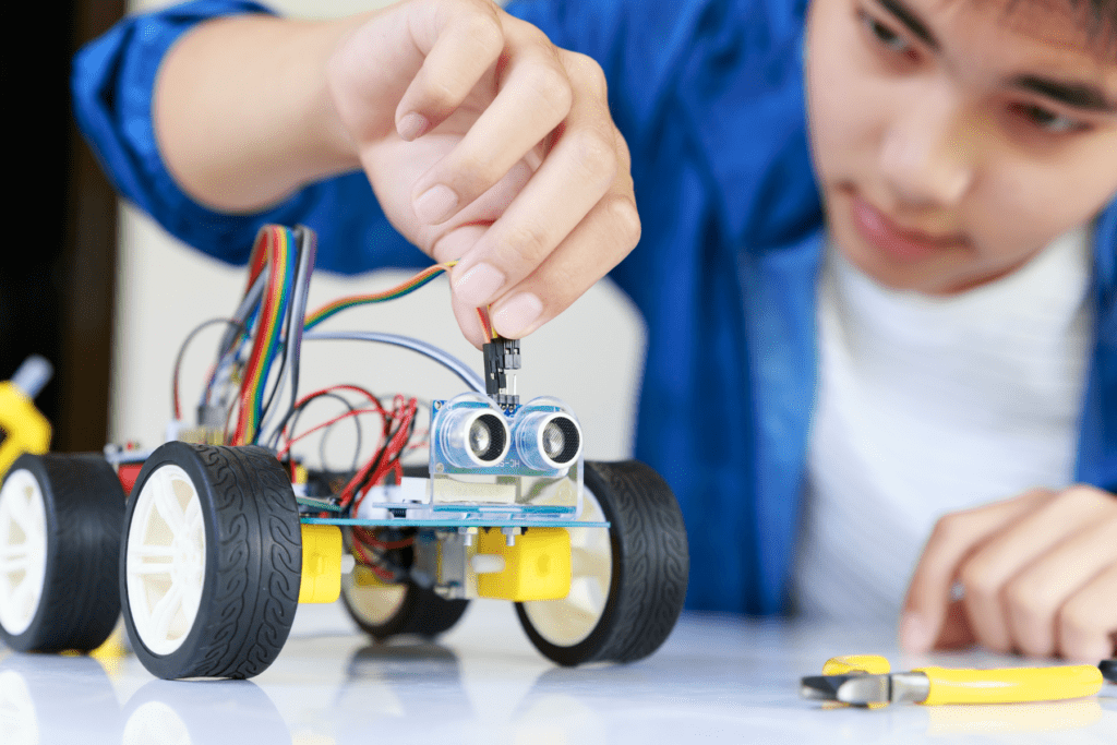 Boy building a robotic car